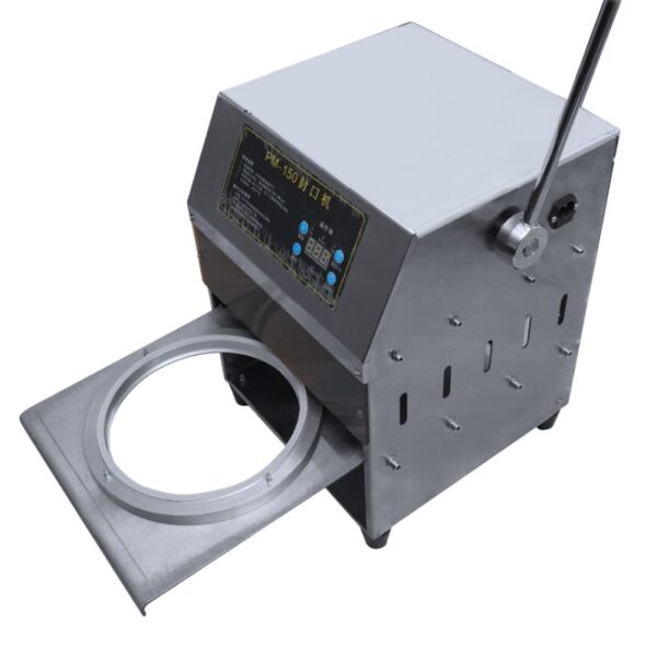 Introducing the Round Shape Lunch Box Semi-Auto Sealing Machine, a stainless steel device equipped with a lever and control panel, showcasing an open circular compartment at the front.