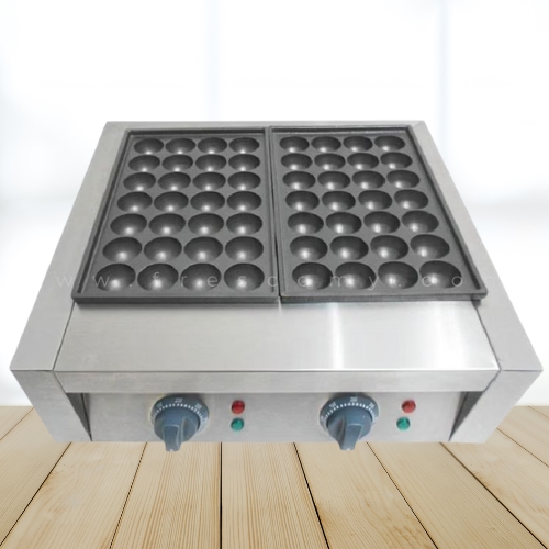 A stainless steel commercial takoyaki machine with two plates, each featuring multiple round molds, sits on a wooden surface—perfect for a takoyaki shop or anyone learning how to make takoyaki at home.