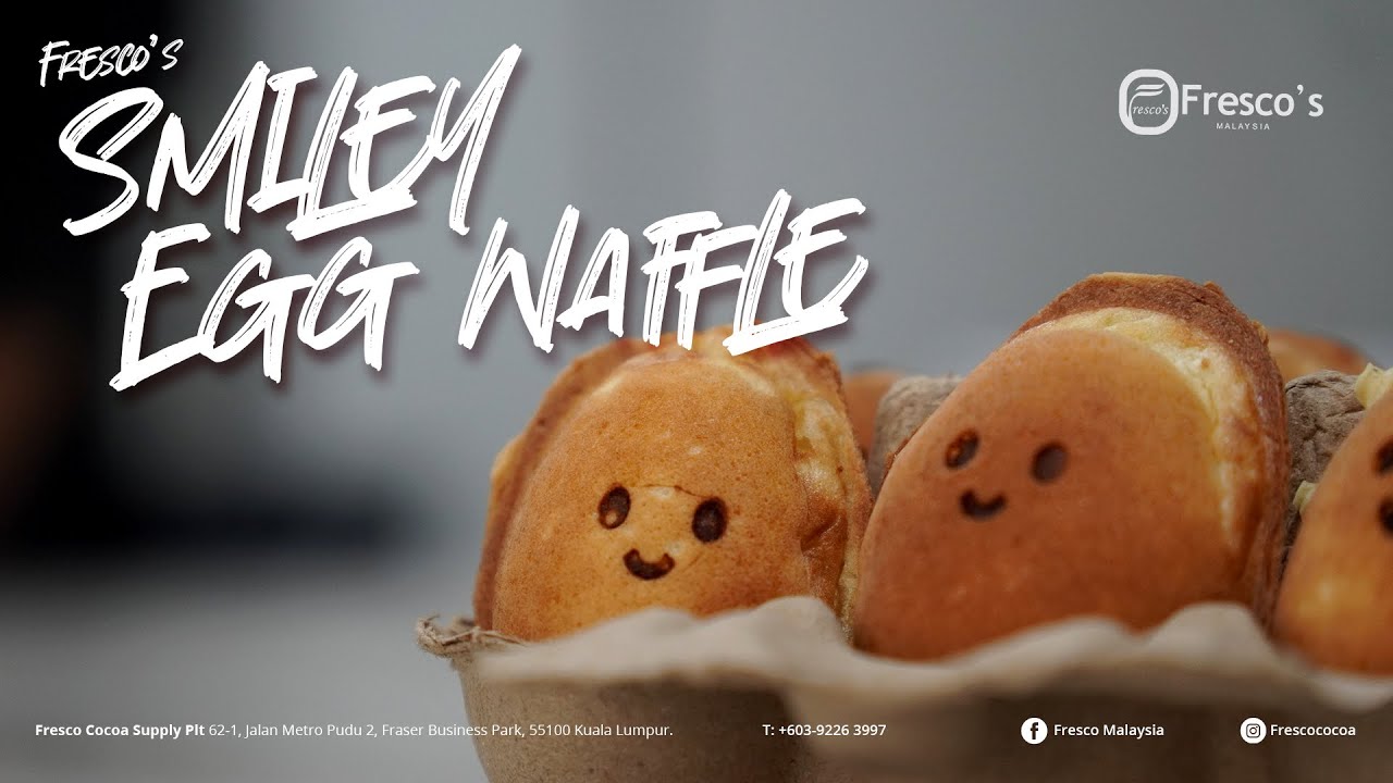 Close-up of egg waffles with smiley faces, served as a menu item for Fresco's Malaysia. Featuring brand logos, contact details, and made using the Fresco ice cream machine for the perfect treat.