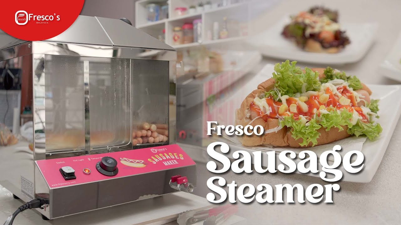 A stainless steel sausage steamer is displayed next to a plate with a steamed hotdog sandwich topped with lettuce and condiments. "Fresco Sausage Steamer" text is overlaid. Perfect for making your favorite hotdog Malaysia style at home.