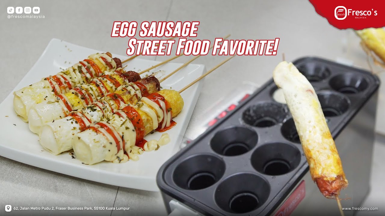 Egg sausages on skewers served with sauces and herbs on a plate, with one egg sausage in a muffin tray next to the plate—perfect to pair with your favorite waffle ball or try alongside a classic waffle balls recipe.