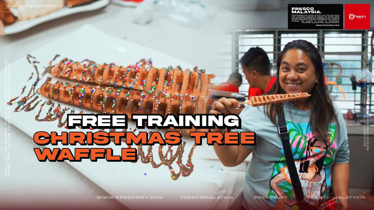 A woman holding a chocolate-drizzled, Christmas tree-shaped waffle made with a waffle machine Malaysia; text reads "Free Training Christmas Tree Waffle.
